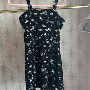 This is a black dress with flowers on it and it is a kids large also worn once.